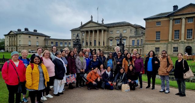 A group of over 30 learners and staff pose for a group photo outside Kedleston Hall stately home.