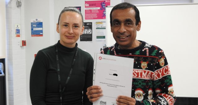 Bhavash receiving his certificate, presented by Amy McManus.