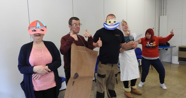 Learners wearing the costumes they have made are lined up ready to rehearse the play they have been learning.