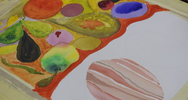 An image of a watercolour painting in progress showing brightly coloured circular shapes resembling planets, with a striped planet painted in pink and cream tones in the foreground.